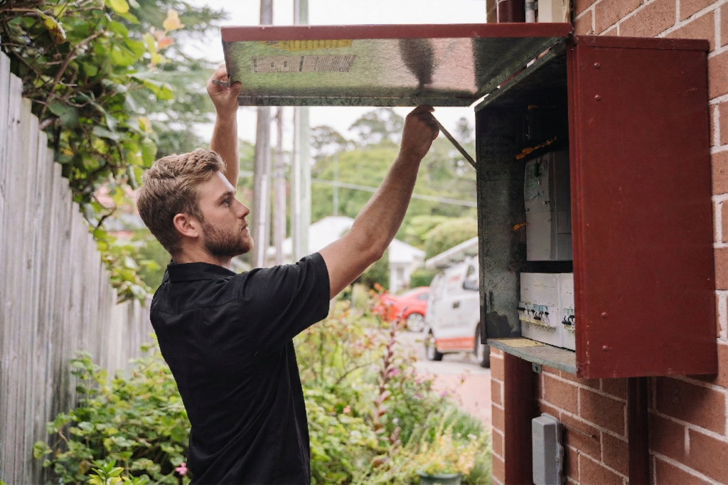 Electrician installing downlights in a Cabarita home